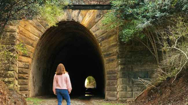 <p>Local historian Liz Vincent conducted ghost tours in Picton, claimed to be Australia's most haunted town, until her death in 2009. Since then her husband John and daughter Jenny Davies have taken up the mantle.</p><p>"Picton's just so haunted," Ms Davies said.</p><p>"We find people always love to see their photos afterwards because most of these things aren't visible to the naked eye."</p><p>One of the tour's most popular figures is Emily, a lady who was hit and killed by a train in 1916 while taking a shortcut through the Redbank Range Tunnel, also known as the Mushroom Tunnel, to visit her brother.</p><p>Emily Bollard resided near the railway line and was a single woman aged in her 50s. Before taking her shortcut, she didn't check the timetable and was hit in the tunnel by a train coming from Thirlmere. She died instantly.</p><p>"She likes to move among the participants and loves to touch their hair and body, particularly their arms and legs," Ms Davies said.</p><p>"Those on the tour often say that they've also felt a cold wind blowing through the tunnel."</p>