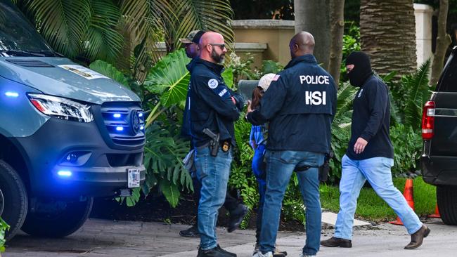 Federal and Homeland Security Investigation agents are seen at the entrance of US producer and musician Sean "Diddy" Combs's home at Star Island in Miami Beach on March 25. Picture: Giorgio Viera/AFP