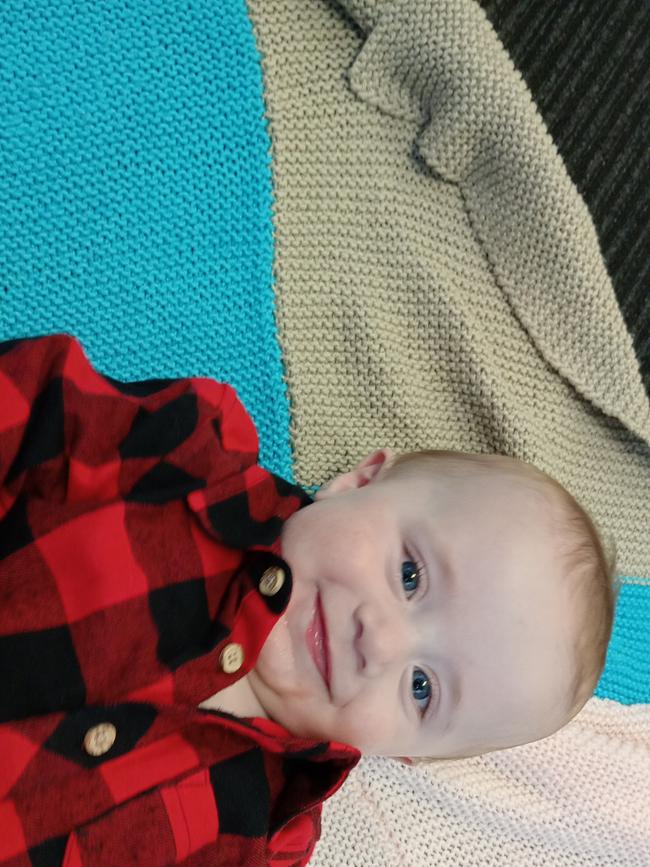 Jaxon, nine months old. Blue eyes, chunky thighs.