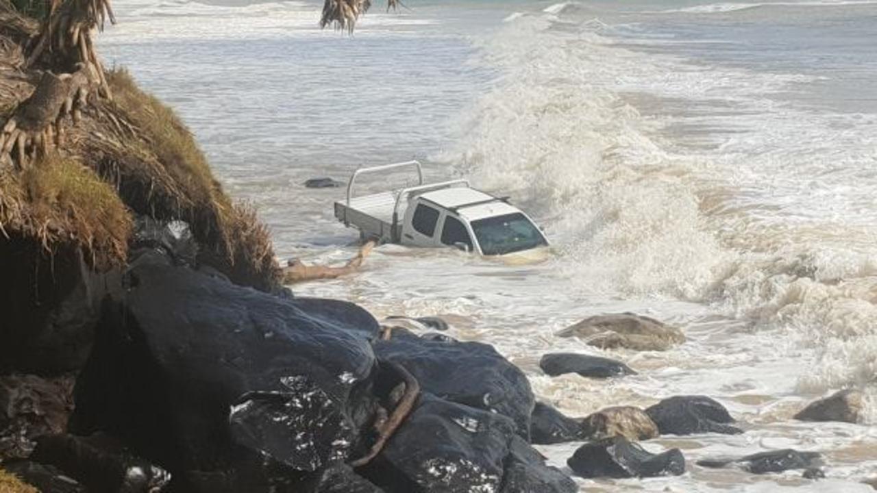 A truck washed off the shoreline by huge swells at Rainbow Beach on the NSW and Queensland border. Picture: Rainbow Beach Towing &amp; Roadside Assist/Facebook