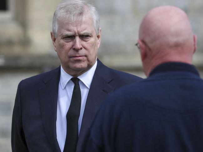 Britain's Prince Andrew, Duke of York (L), talks with Crown Estate staff as he attends the Sunday service at the Royal Chapel of All Saints in Windsor. Picture: Steve Parsons