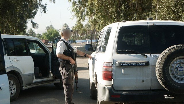 Their daily routine of checking cars for Improvised Explosive Devices (IEDs) before a run through the red and green zones in Baghdad. Picture: Supplied