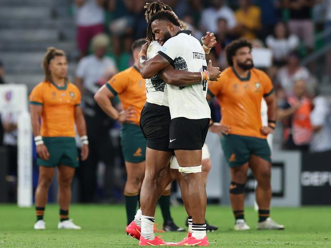 Waisea Nayacalevu embraces Fijian teammate Lekima Tagitagivalu after victory over the Wallabies at the 2023 Rugby World Cup. Picture: Phil Walter/Getty Images