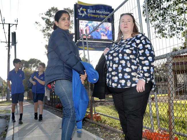 Popular north-eastern suburbs school caught up in public health alert after lead-based black ceiling dust fell from building roof. Concerned parents, (LtoR) Sarah and Lisa, have several children at the school between them, and want to know what is going on. 28 June 2022. Picture Dean Martin