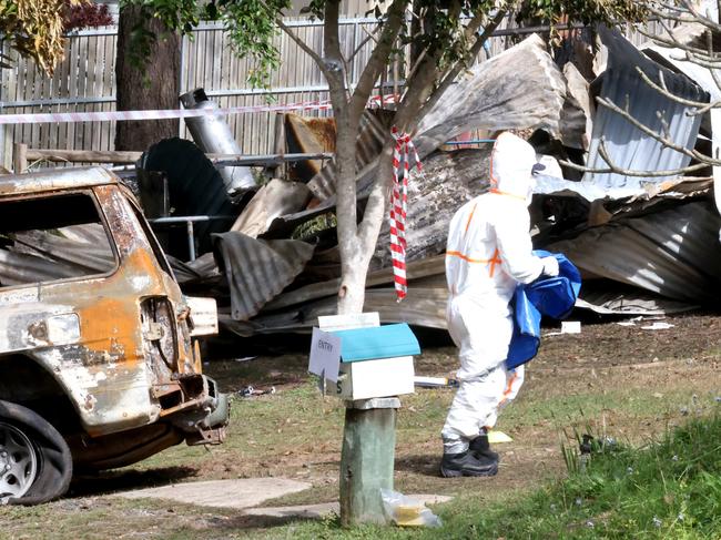 Authorities remain at the scene of the deadly house fire. Picture: Steve Pohlner