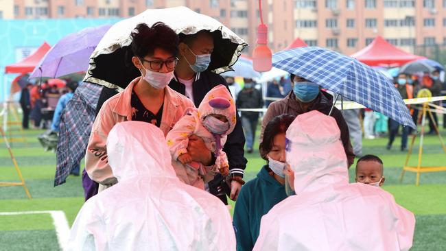 People line up to be tested for COVID-19 as part of a mass testing program in Qingdao in China's eastern Shandong province. Picture: AFP