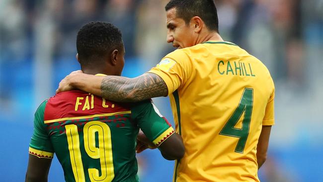 Tim Cahill puts his arm around Collins Fai after the 1-1 draw with Cameroon.