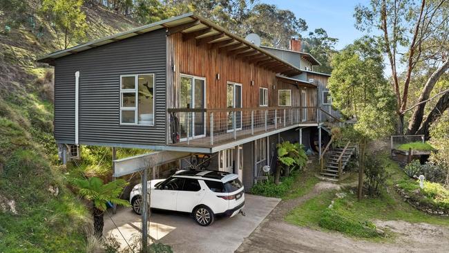 The four-bedroom house is set in a valley with pristine bushland.