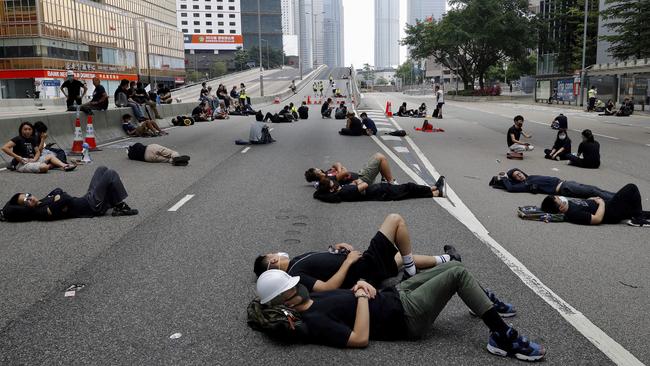 Protesters sleep on the main road near the Legislative Council yesterday, to protest against the extradition bill.