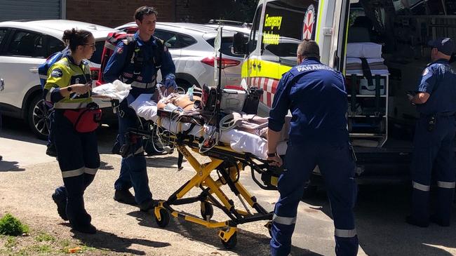 A man is taken to an ambulance outside the Andrew 'Boy' Charlton Aquatic Centre in Manly after suffering an apparent seizure while swimming. Picture: Julie Cross