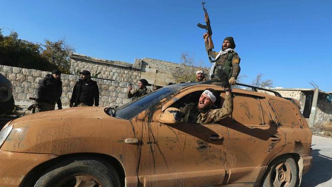 Anti-government fighters celebrate in a street in Maaret al-Numan in Syria's northwestern Idlib province. Picture: AFP