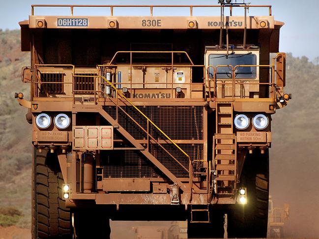 A heavy earth moving truck at the Tom Price iron ore mine, operated by Rio Tinto Group, is lit up by the afternoon sun in Pilbara, north Western Australia on Wednesday, July 26, 2006. BHP Billiton Ltd., the world's largest mining company, is losing the support of investors and steelmakers for its proposed $128 billion takeover of Rio Tinto Group. Photographer: Jack Atley/Bloomberg News