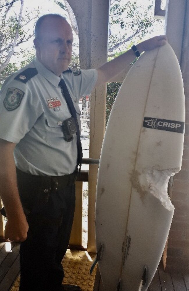 Inspector Matt Kehoe with Mr Edwardes’ damaged surfboard. 