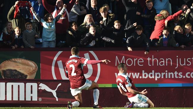 Burnley's English midfielder Dean Marney (R) celebrates after scoring.