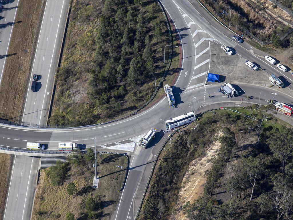 The bus rolled onto its side, on top of a roadside guardrail. Picture: NCA NewsWire / Christian Gilles