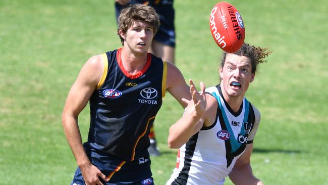 Jordon Butts, left, of the Crows and Wylie Buzza of the Power. Picture: David Mariuz/AAP