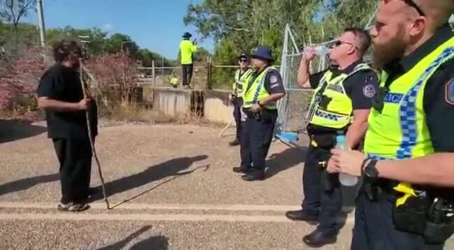 A Larrakia woman protests against the development of Lee Point as bulldozers begin land clearing