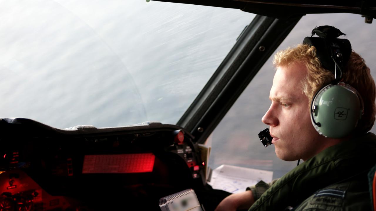 Royal Australian Air Force Flight Lieutenant Philip Tracey searches over the Indian Ocean to try to find flight MH370.