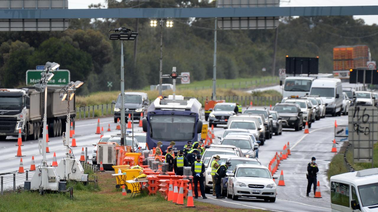 Police and ADF personnel at a checkpoint on the Princes Freeway at Little River on Thursday morning. Picture: Andrew Henshaw