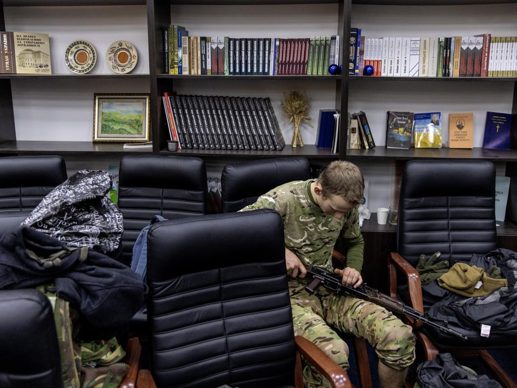 A civilian volunteer fixes his gun in Kyiv, Ukraine. Picture: Chris McGrath/Getty Images