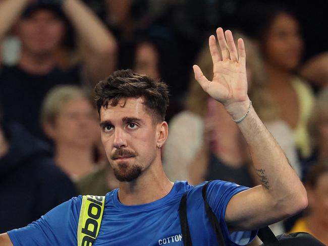 Australiaâs Thanasi Kokkinakis waves to the crowd as he leaves the court following his defeat to Britainâs Jack Draper in the men's singles match on day four of the Australian Open tennis tournament in Melbourne on January 15, 2025. (Photo by DAVID GRAY / AFP) / -- IMAGE RESTRICTED TO EDITORIAL USE - STRICTLY NO COMMERCIAL USE --