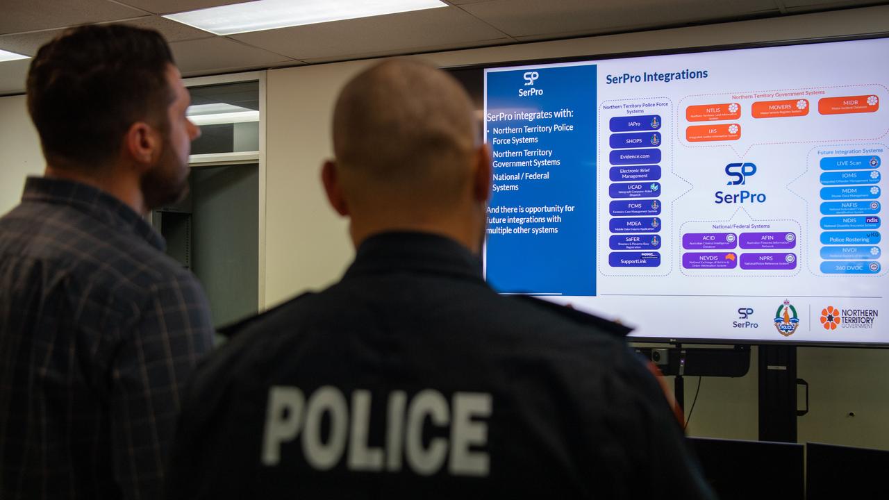 Minister Brent Potter and Acting Commander John Atkin looks at the SerPro, a modern, proven and integrated digital policing system in the NT. Picture: Pema Tamang Pakhrin