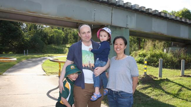 Algester residents Mallory Wuthrich and Mei-Ya Lin with their children Joshua, 5, and Madeleine, 2 at Col Bennett Park under the existing train track. Photo: Kristy Muir