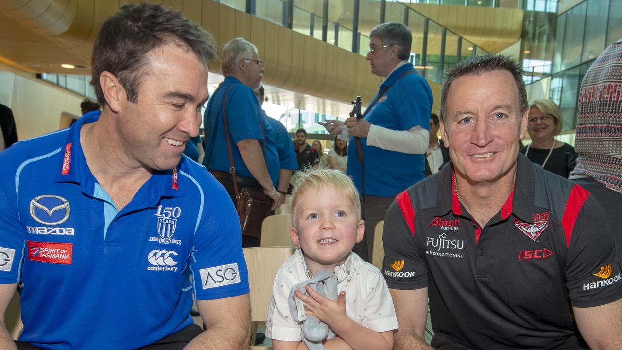North Melbourne coach Brad Scott and Essendon coach John Worsfold, with Ollie, at the launch of the Good Friday Appeal. Picture: Jay Town