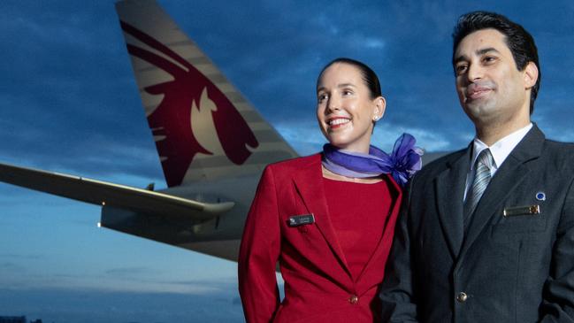 BRISBANE, AUSTRALIA - DECEMBER 04: In this image released on December 12, crew from both Virgin Australia and Qatar Airways beside a Qatar Airways Boeing 777 at Brisbane Airport on December 04, 2024 in Brisbane, Australia. A new partnership between the two airlines has been launched which will deliver more value and choice to Australians, providing opportunities to travel to over 100 destinations across Europe, the Middle East and Africa. From December 12, Aussies can book Virgin Australia's new direct services from Sydney, Brisbane and Perth to Doha for travel from June 2025, with Melbourne set to launch later in 2025. These flights will be operated by Virgin Australia using Qatar Airways' spacious Boeing 777s, renowned for their Qsuite Business Class. (Photo by James D. Morgan/Getty Images for Virgin Australia)