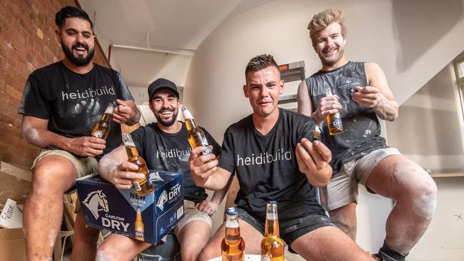 Tradies Joel Griffs, Luke Smith, Brody MacDonald, and Josh Lanyon try to work the new smaller bottles. Picture: Jason Edwards