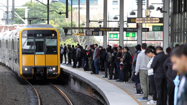 Passengers wait to board a train at Parramatta station.