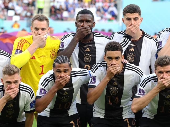 DOHA, QATAR - NOVEMBER 23: Germany players pose with their hands covering their mouths as they line up for the team photos prior to the FIFA World Cup Qatar 2022 Group E match between Germany and Japan at Khalifa International Stadium on November 23, 2022 in Doha, Qatar. (Photo by Alexander Hassenstein/Getty Images)