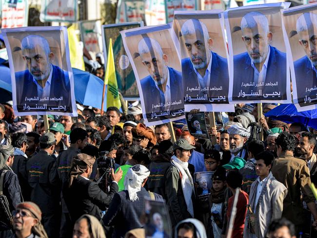 TOPSHOT - Supporters of Yemen's Huthis gather with pictures of Hamas' slain leader Yahya Sinwar during a rally held in the Huthi-controlled capital Sanaa on October 18, 2024 in protest against Israel's attacks on Lebanon and the ongoing war between Israel and Hamas militants in the Gaza Strip. Israel announced on October 17 the killing of Sinwar, mastermind of the October 7 attack, calling his death a "heavy blow" to the Palestinian group it has been fighting for more than a year. (Photo by Mohammed HUWAIS / AFP)