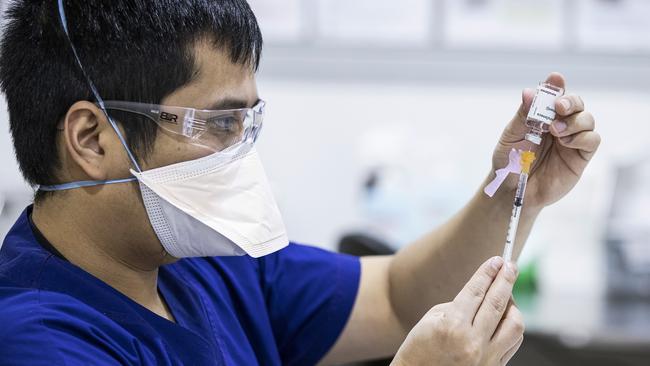 Staff prepare AstraZeneca vaccine doses inside the Melbourne Showgrounds COVID-19 Vaccination Centre. Picture: Getty Images