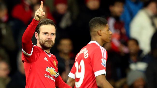 Manchester United's Juan Mata celebrates scoring his side's first goal of the game, during the English Premier League soccer match between Manchester United and Watford, at Old Trafford, in Manchester, England, Wednesday March 2, 2016. (Martin Rickett/PA via AP) UNITED KINGDOM OUT NO SALES NO ARCHIVE