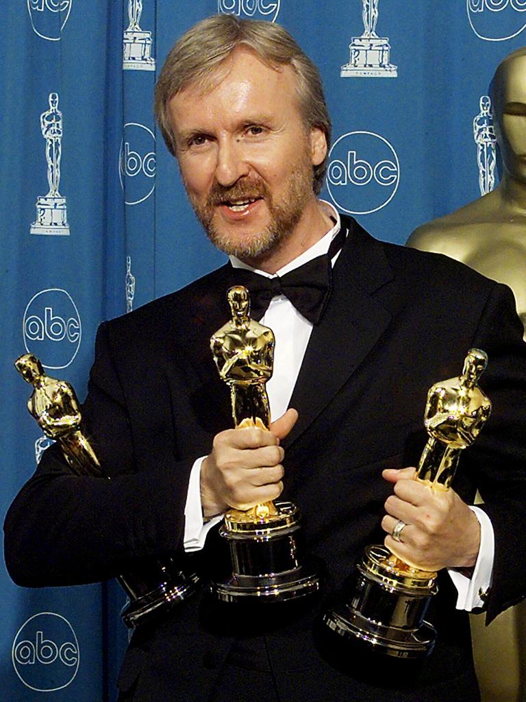 James Cameron holds the three Oscars he won for Best Film, Best Director &amp; Best Editing for Titanic in 1998.