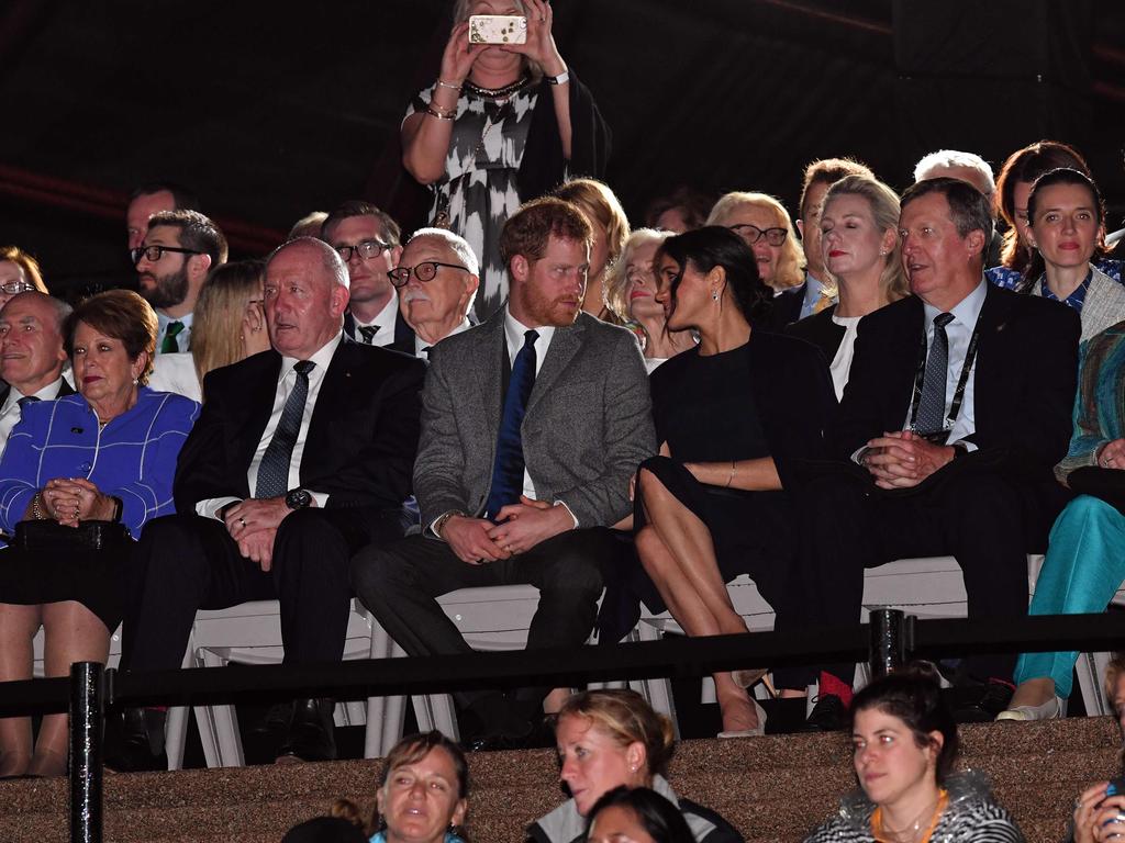 Prince Harry and wife Meghan look affectionate during the opening ceremony of the Invictus Games in Sydney. Picture: Saeed Khan