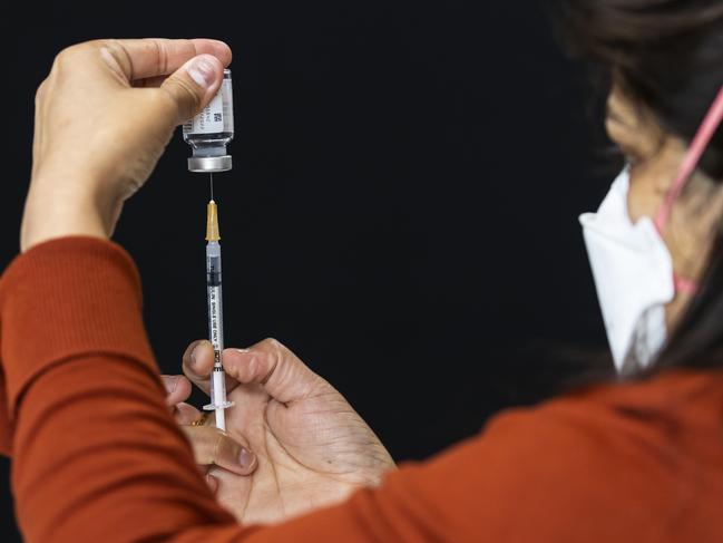 MELBOURNE, AUSTRALIA - NewsWire Photos October 15, 2021:  Health staff prepare syringes with doses of the Moderna vaccination inside the pharmacy at a pop-up COVID vaccination hub at Casey Fields in Cranbourne, Melbourne, Victoria. Picture: NCA NewsWire / Daniel Pockett