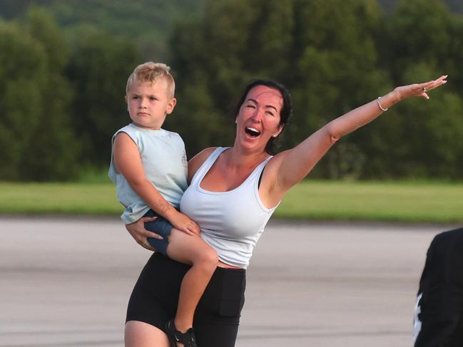 Australian citizens react with joy after arriving back home from Vanuatu.