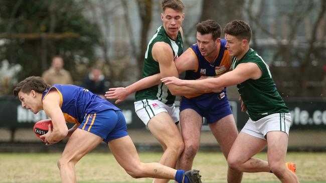 EFL: Lilydale’s Riley Clausen gets a helping hand to break clear. Picture: Hamish Blair