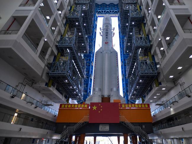 This photo taken on July 17, 2020 shows a Long March 5 rocket being transferred before a planned launch in Wenchang in China's southern Hainan province. - After sending humans into orbit and landing a probe on the Moon, China is aiming for another milestone in its space ambitions with the launch of a Mars rover between July 20 and 25. (Photo by STR / AFP) / China OUT