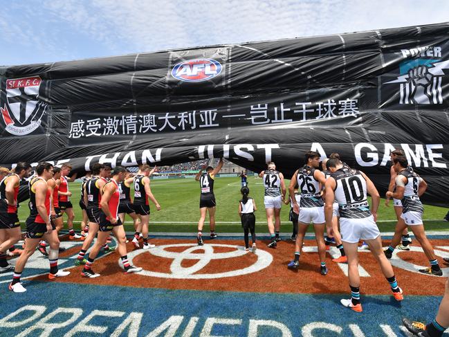 Players run through the banner in 2019. Picture: David Mariuz