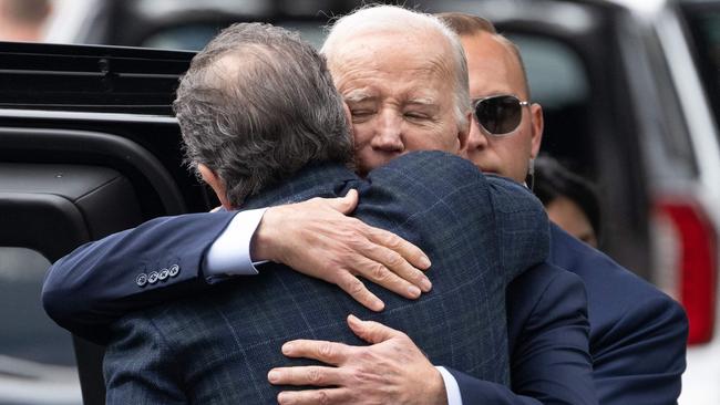 US President Joe Biden hugs his son Hunter Biden as they leave The Ivy restaurant in Los Angeles, California.