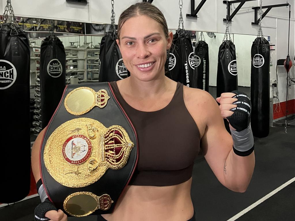 Gold Coast boxer Che Kenneally with her WBA light heavyweight world champion belt at the Fite Klub gym in Burleigh, where she trains under Fidel Tukel. Picture: Mitch Bourke.