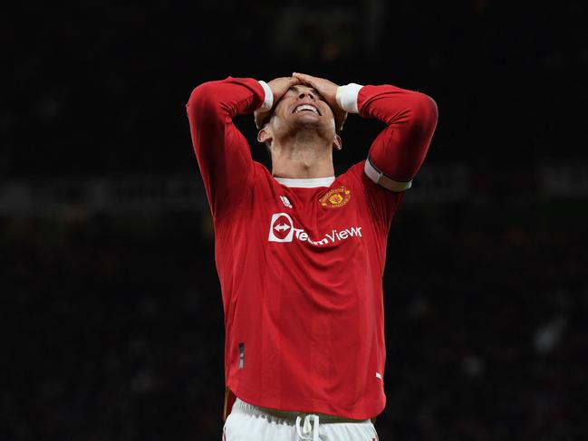 Manchester United's Portuguese striker Cristiano Ronaldo reacts to a missed chance during the English Premier League football match between Manchester United and Wolverhampton Wanderers at Old Trafford in Manchester, north west England, on January 3, 2022. (Photo by Paul ELLIS / AFP) / RESTRICTED TO EDITORIAL USE. No use with unauthorized audio, video, data, fixture lists, club/league logos or 'live' services. Online in-match use limited to 120 images. An additional 40 images may be used in extra time. No video emulation. Social media in-match use limited to 120 images. An additional 40 images may be used in extra time. No use in betting publications, games or single club/league/player publications. /