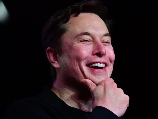 (FILES) In this file photo taken on March 14, 2019 Tesla CEO Elon Musk reacts during the unveiling of the new Tesla Model Y in Hawthorne, California. - Tesla's surging stock value has boosted Elon Musk further up the list of top billionaires as he stands poised for yet another massive payout as soon as this week. (Photo by Frederic J. BROWN / AFP)