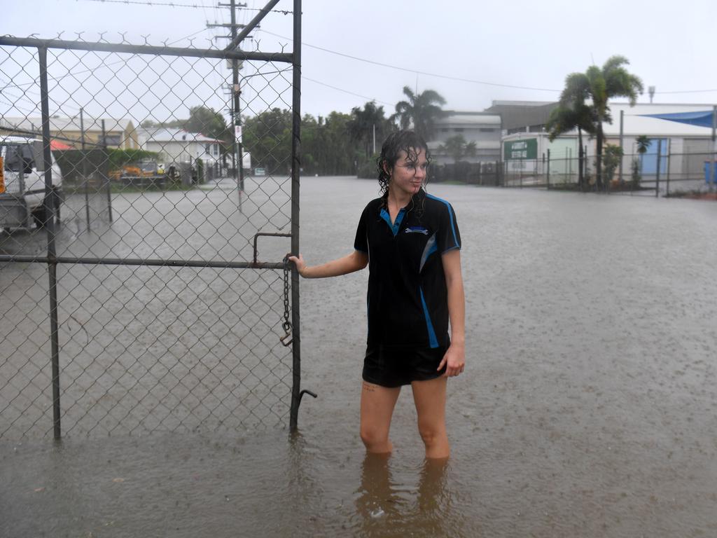 Erin Hollaway locks up a gate in Camgulia Street, Mt Louisa. Picture: Evan Morgan