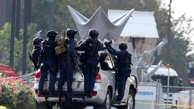 STAR Group officers climb onto their truck after the siege ended. Picture: Sarah Reed.