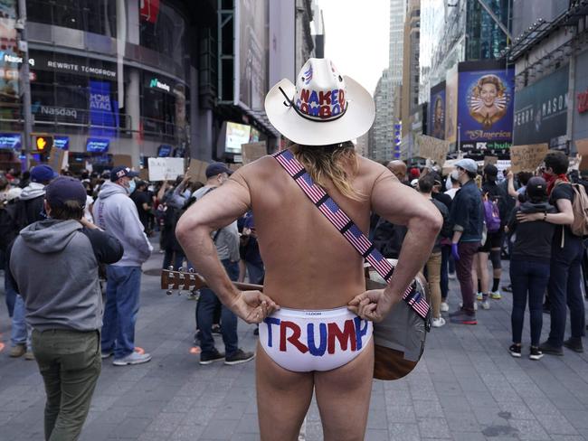 Local street performer Robert John Burck, better known as the Naked Cowboy, looks on at NYPD and protesters in Times Square in New York. Picture: AFP