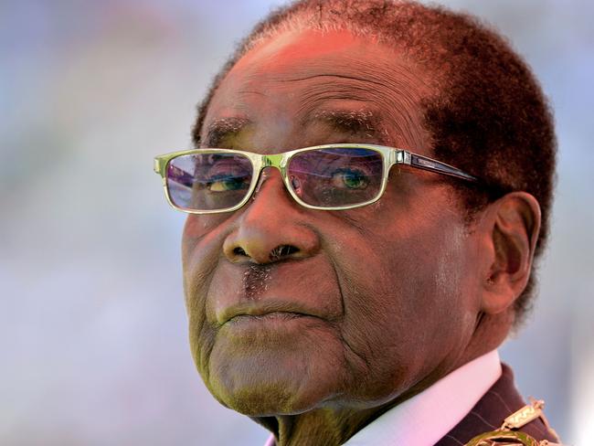 (FILES) In this file photo taken on August 22, 2013, Zimbabwean then President Robert Mugabe looks on during his inauguration and swearing-in ceremony at the 60,000-seater sports stadium in Harare. Veteran Zimbabwean President Robert Mugabe was sworn in as Zimbabwe's president for another five-year term before a stadium packed with tens of thousands of jubilant supporters. - Robert Mugabe, who has died aged 95, used repression and fear to hold on to power in Zimbabwe for 37 years until he was finally ousted when his previously loyal military generals turned against him. (Photo by ALEXANDER JOE / AFP)